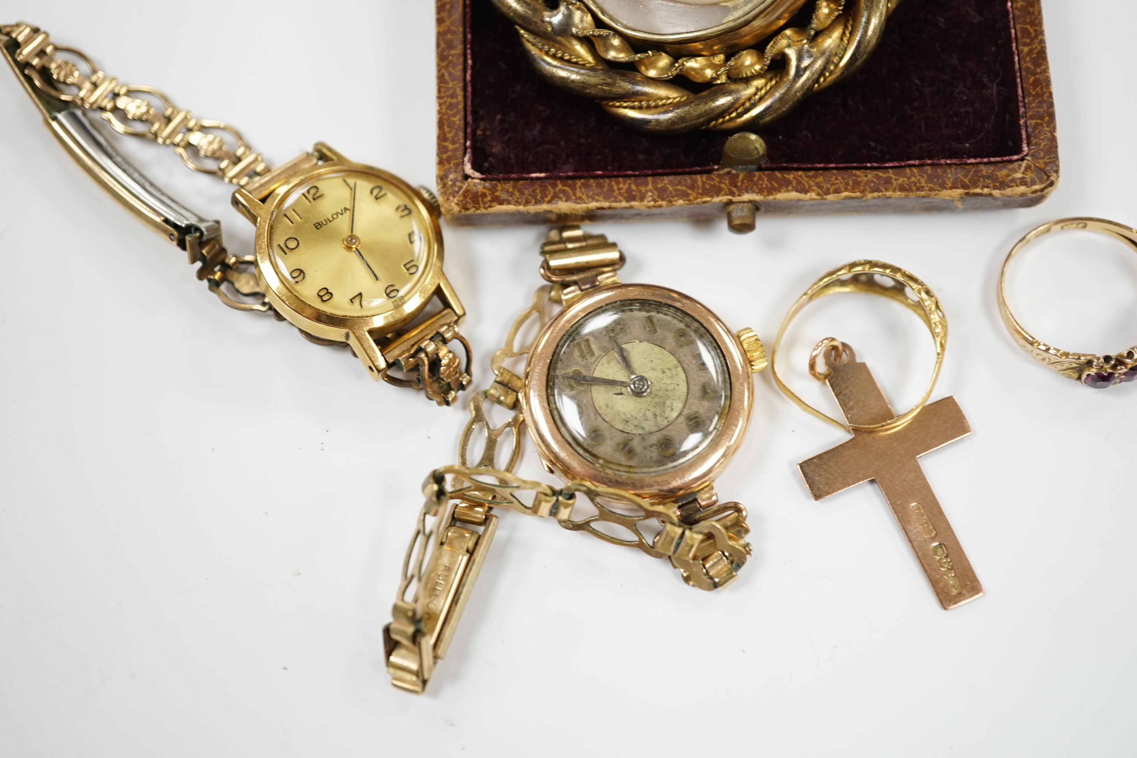 A Victorian 15ct gold and four (ex 5) stone garnet set half hoop ring, an 18ct gold ring, two lady's wrist watches including 9ct gold cased, a 9ct gold cross pendant and a gilt metal and cameo shell set brooch.